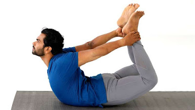 man doing yoga pose, Bow Pose (Dhanurasana)