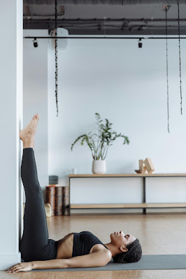 A Woman Doing Yoga. Legs Up the Wall Pose (Viparita Karani)
