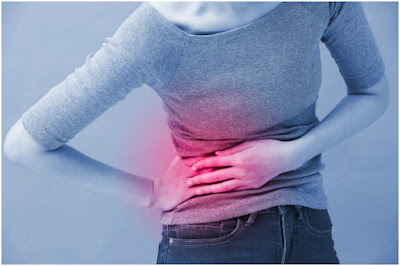 Woman holding her back indicating back pain.